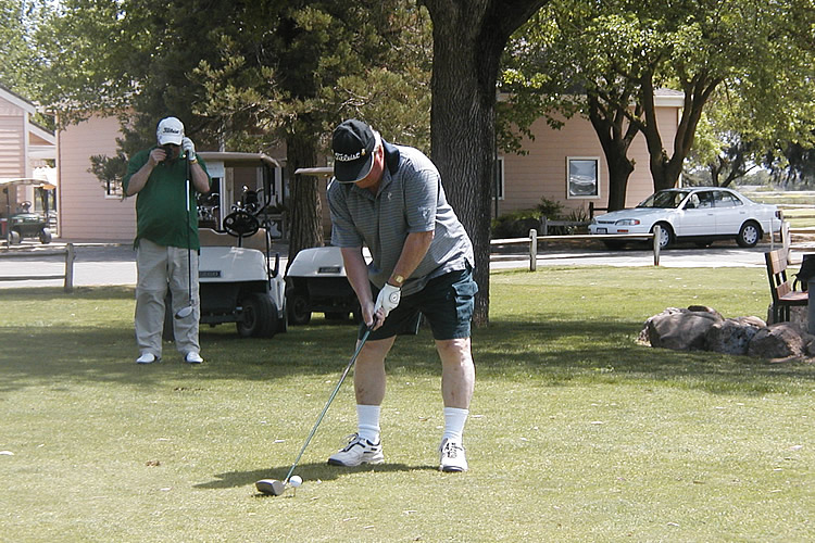 Bob teeing off at the golf tournament