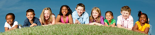 children on a grassy hill