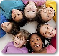 children in a circle smiling